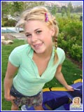 Blonde cutie Little Summer in pigtails outdoors